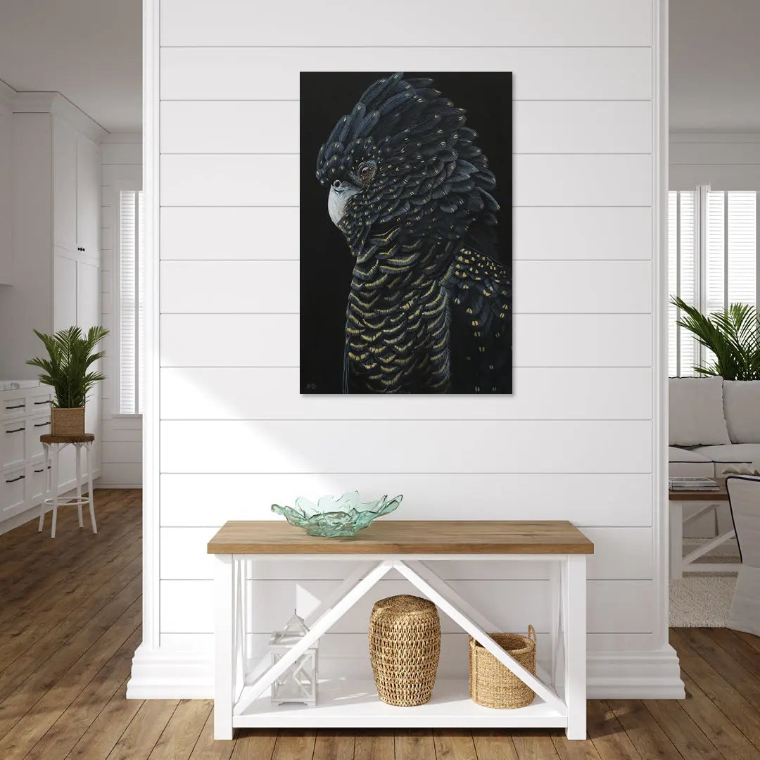 Framed artwork of a bird on a white wall above a wooden console table.