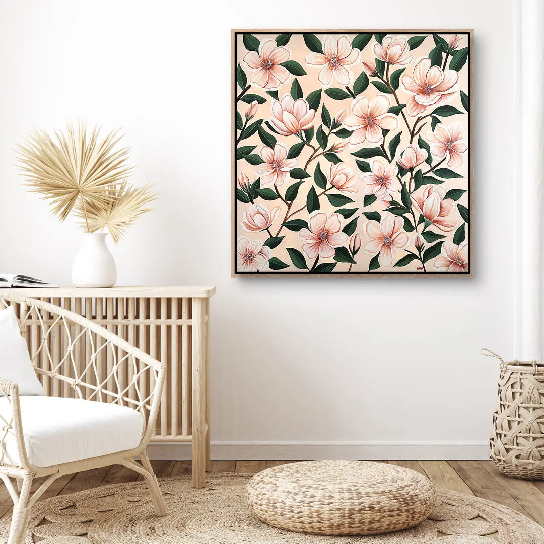 Floral artwork on a wall in a room with a chair and decorative items.
