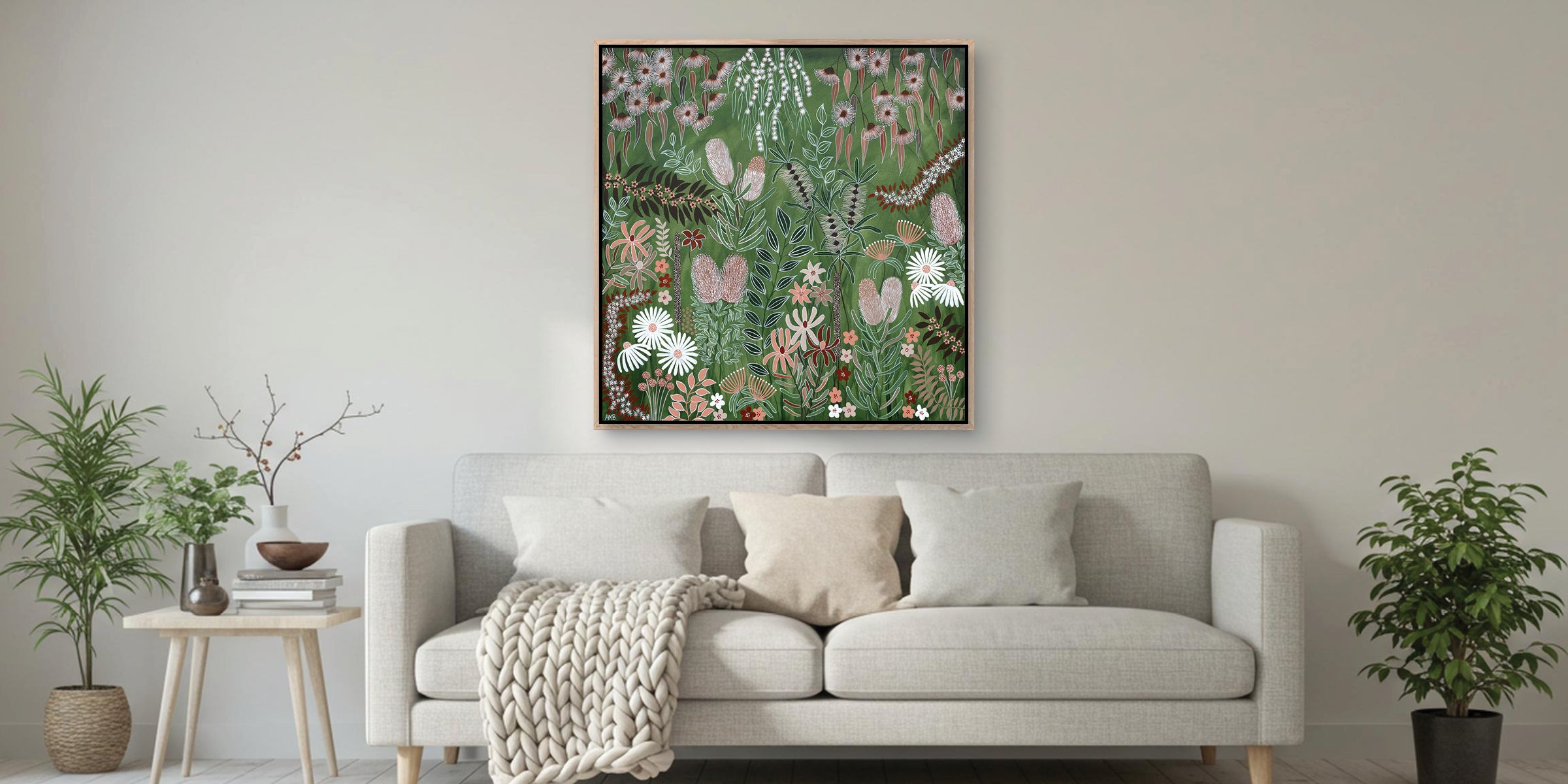 Living room with a gray sofa, decorative plants, and a floral painting on the wall.