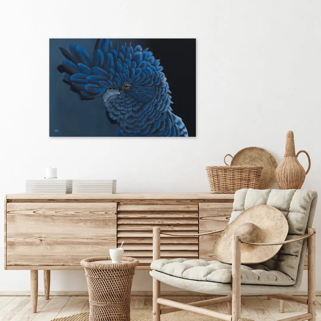 Living room with wooden furniture, wicker basket, and decorative items, featuring a blue parrot artwork on the wall.