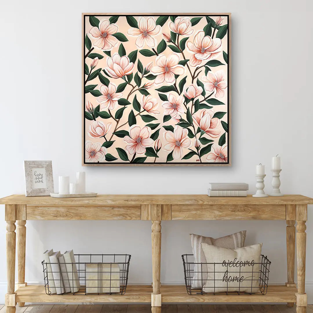 Floral artwork above a wooden console table with decorative items.