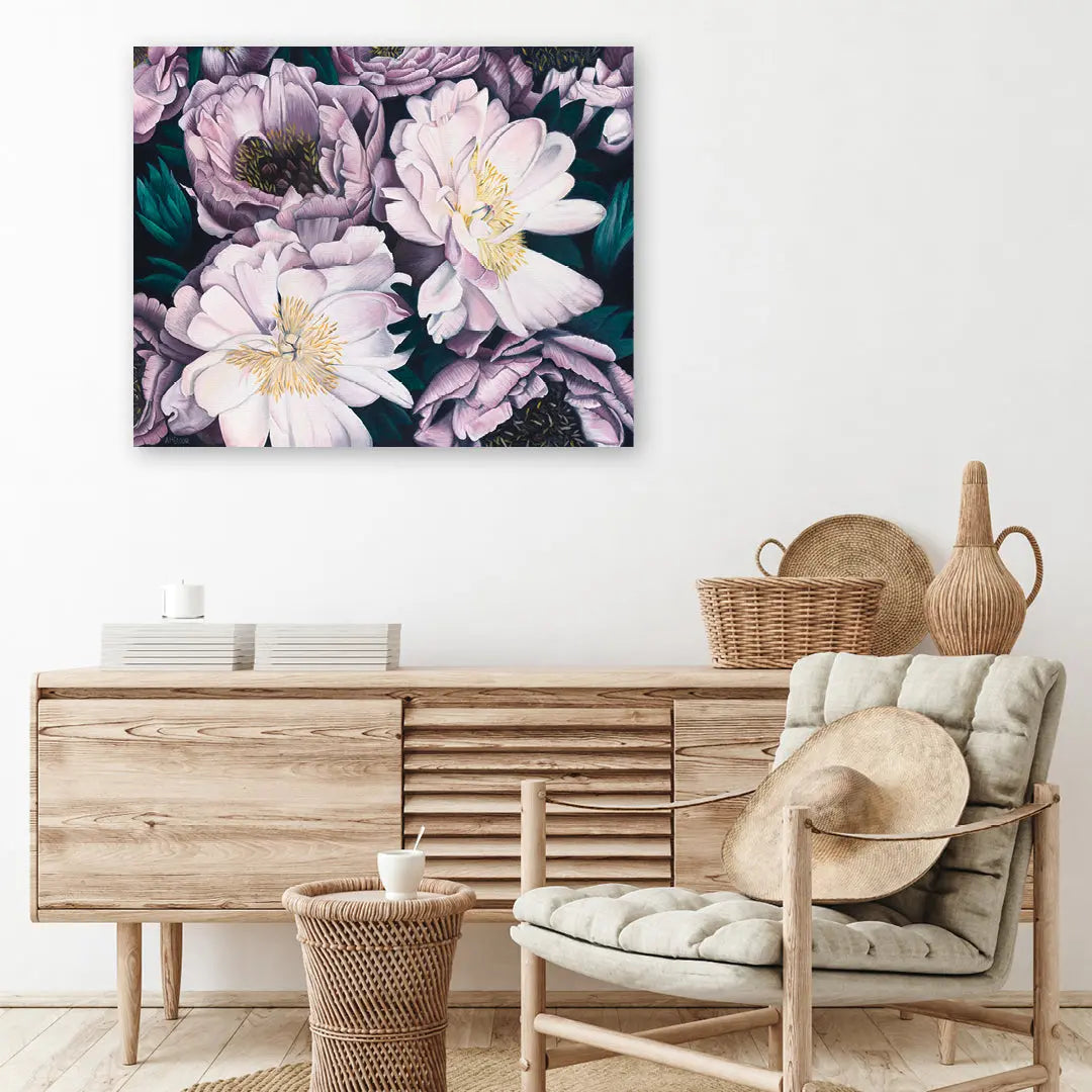 Floral painting above a wooden sideboard with a chair and decorative items in a room.